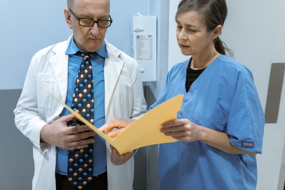 A doctor and nurse reviewing a care case
